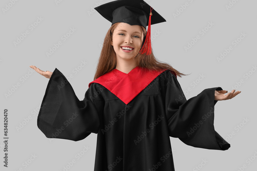 Female graduate student on grey background