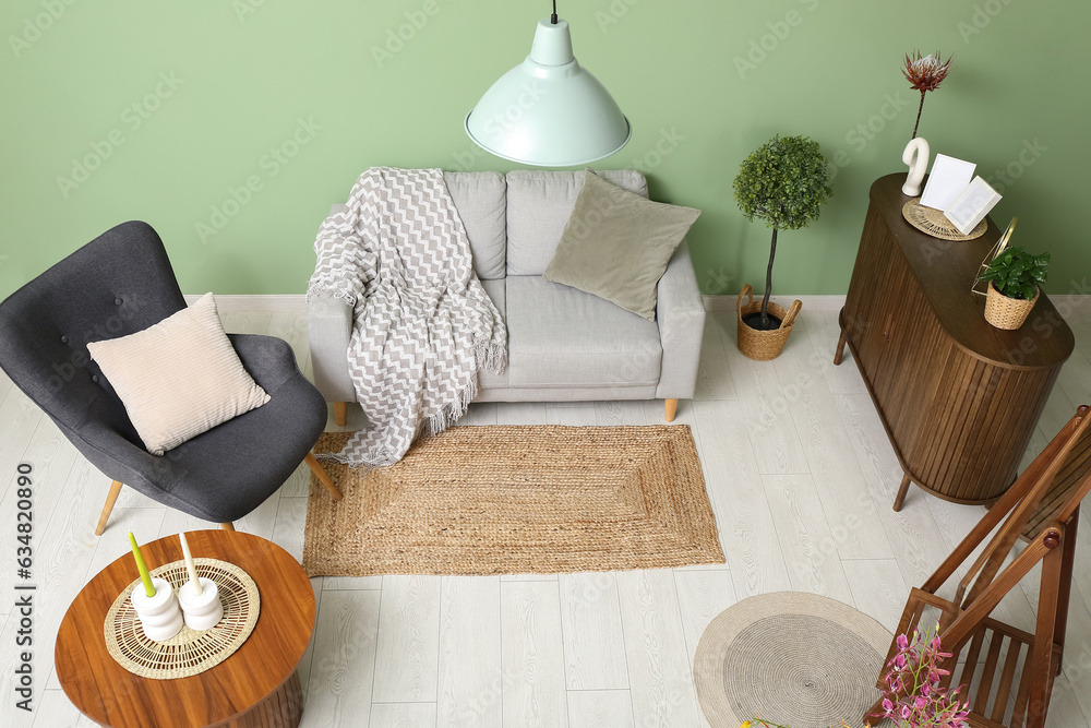 Modern living room interior with grey sofa, armchair and coffee table