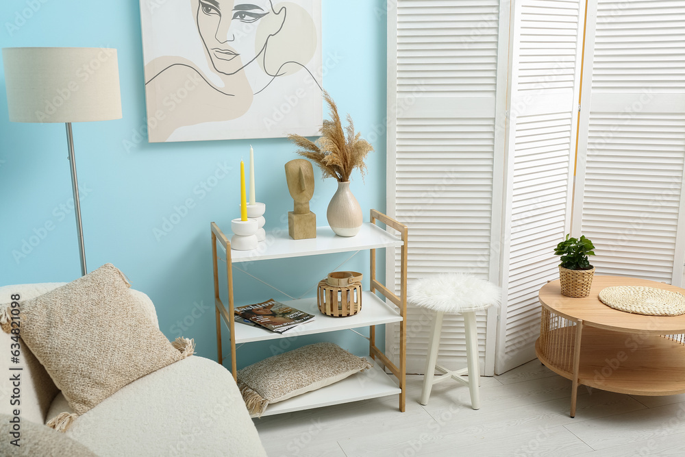 Modern living room interior with shelving unit, coffee table and folding screen