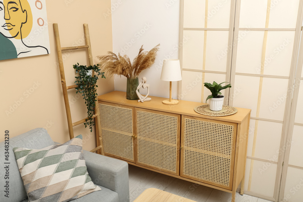 Modern living room interior with cabinet, plants and folding screen