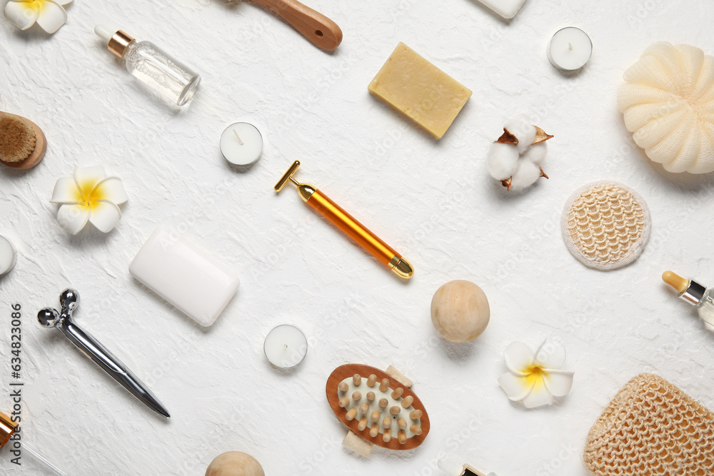 Composition with different spa accessories and flowers on light background