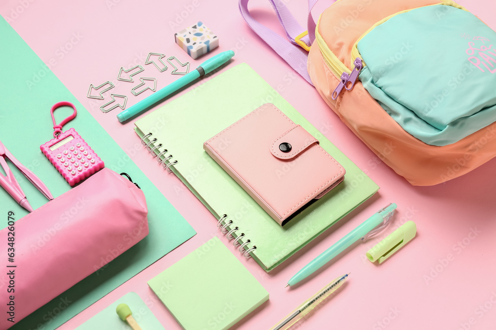 Stylish school backpack and pencil case with different stationery supplies on colorful background