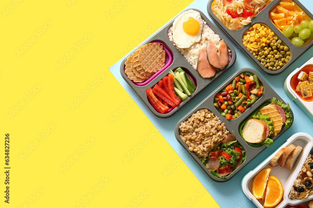 Many lunchboxes with different delicious food on color background