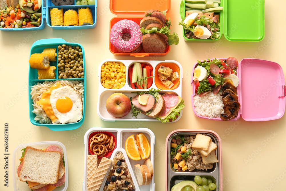 Many lunchboxes with different delicious food on pale yellow background