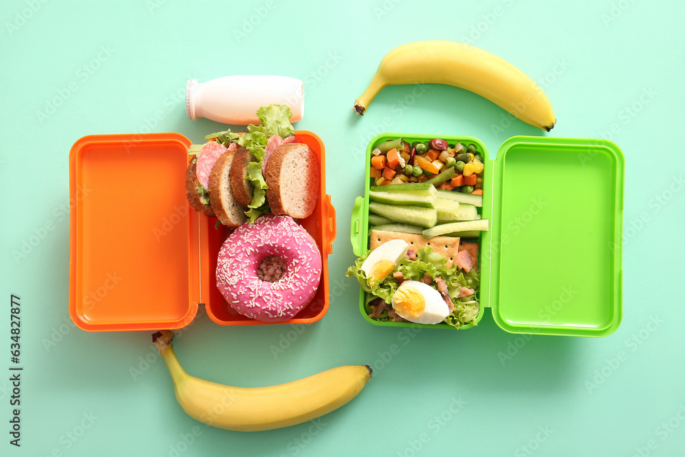 Lunchboxes with different delicious food on turquoise background