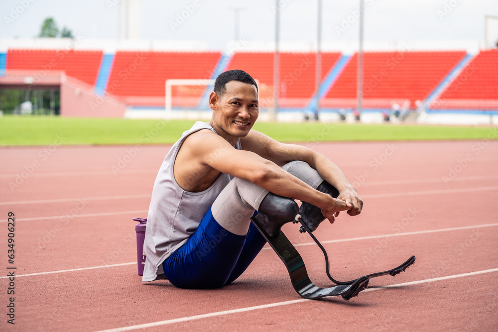 Portrait of Asian para-athletes disabled with prosthetic in stadium. 