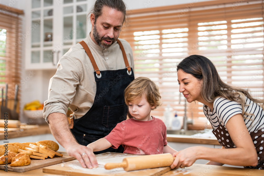 Caucasian attractive couple baking bakery with son in kitchen at home. 