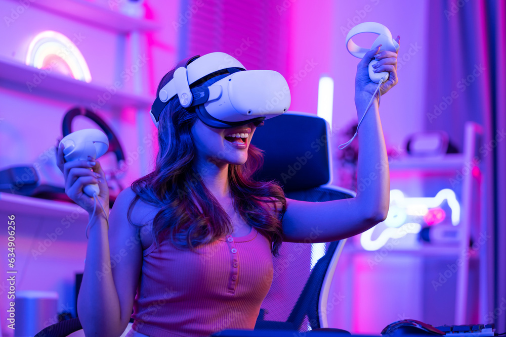 Asian young Esport woman gamer use technology VR glasses and play game. 