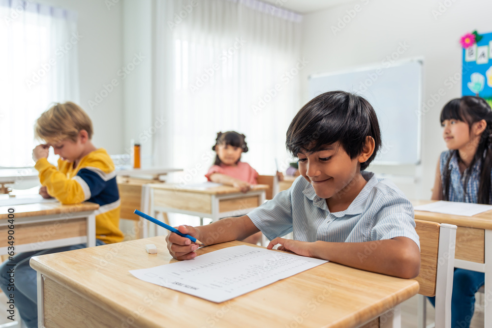 Group of student learn with teacher in classroom at elementary school. 