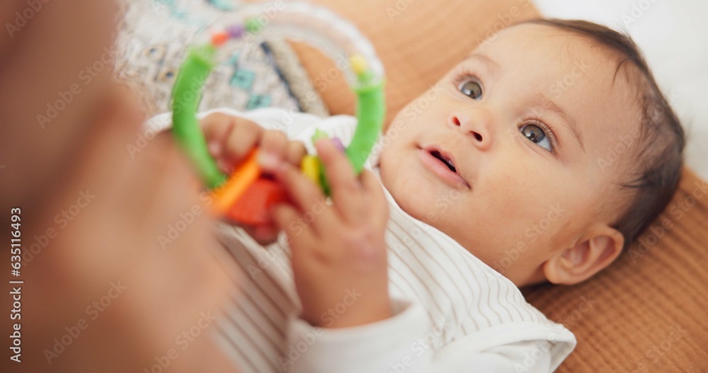 Sweet, playing and cute baby with a toy on a blanket for child development, fun and entertainment. H