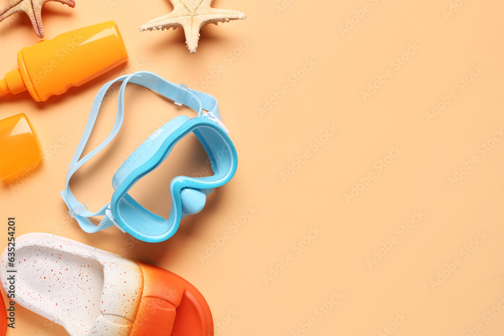 Composition with snorkeling mask, flip-flops and bottle of sunscreen cream on color background