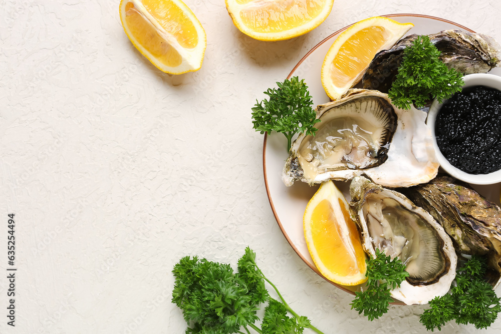 Plate of tasty oysters with lemon and black caviar on white background