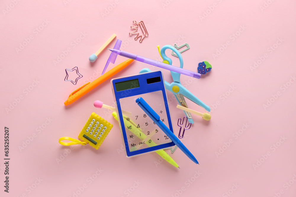 Colorful stationery flying on pink background