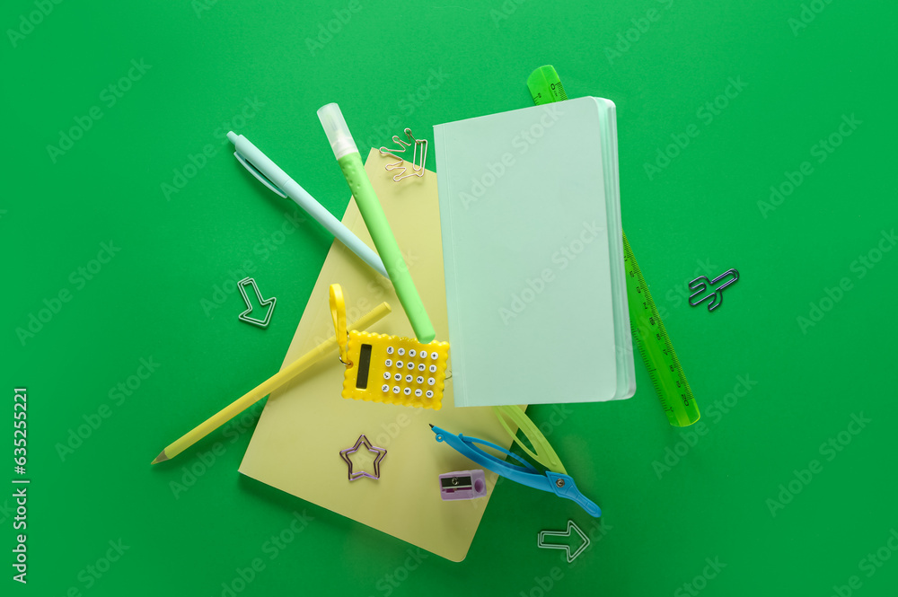 Stationery flying on green background