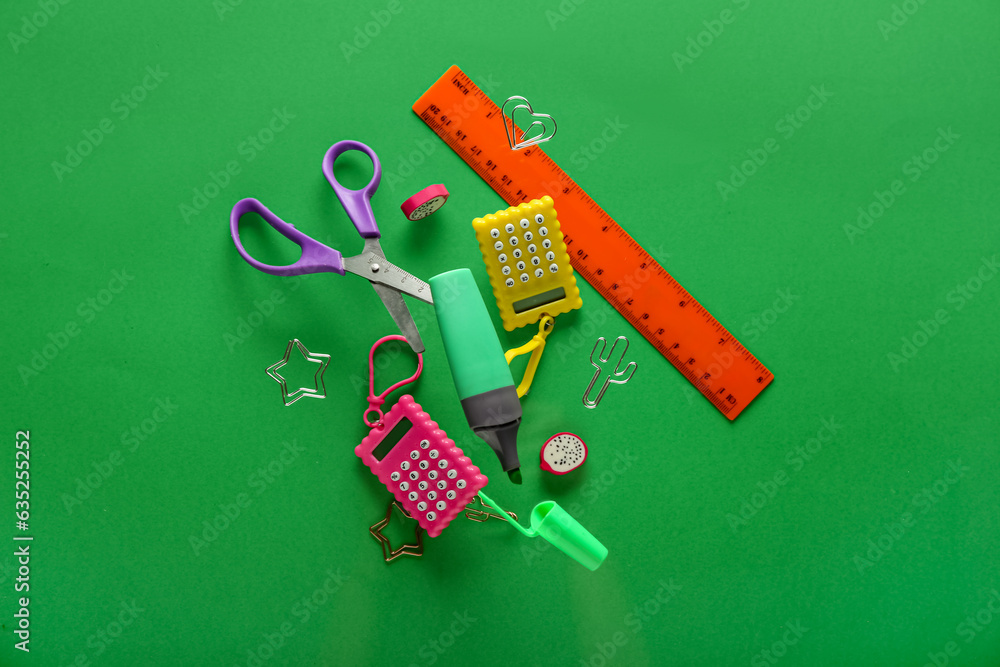 Different stationery flying against green background