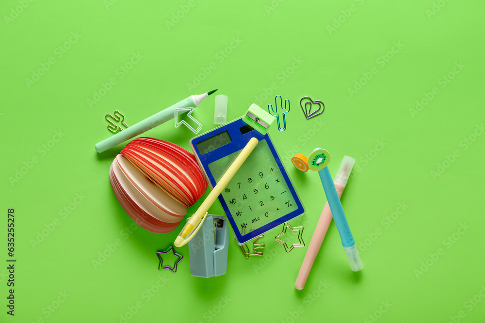 Set of stationery flying on green background