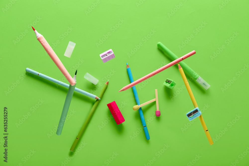 Set of stationery with color pencils flying on color background