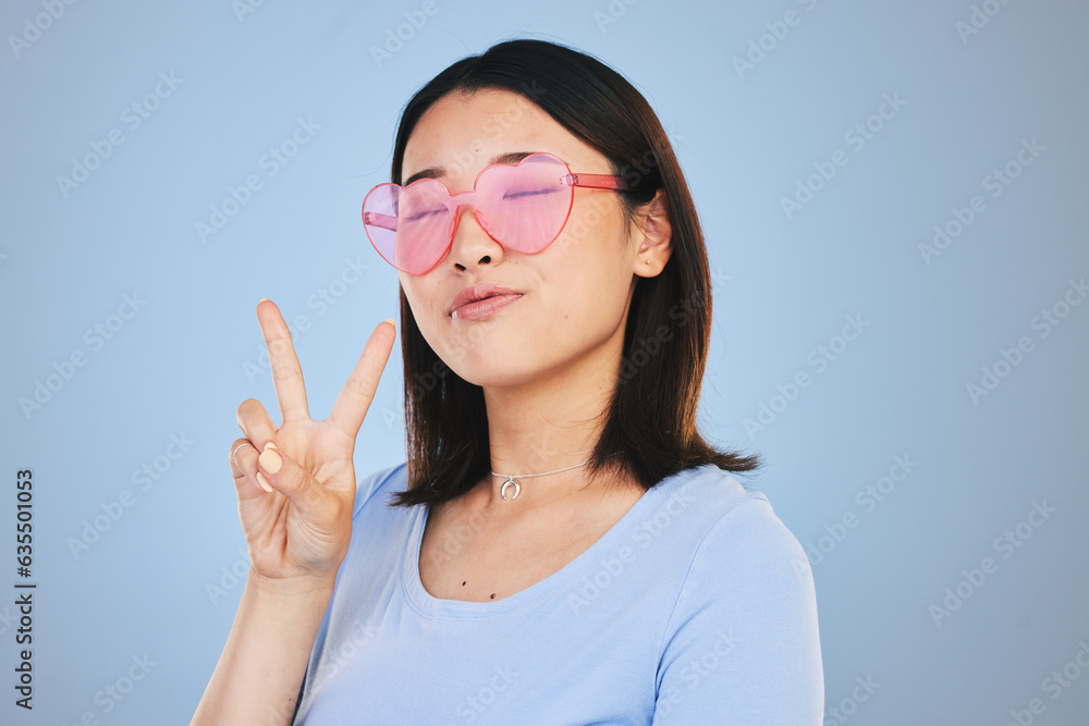 Peace, sign and portrait of woman with hand for emoji in studio blue background with gen z style, fa