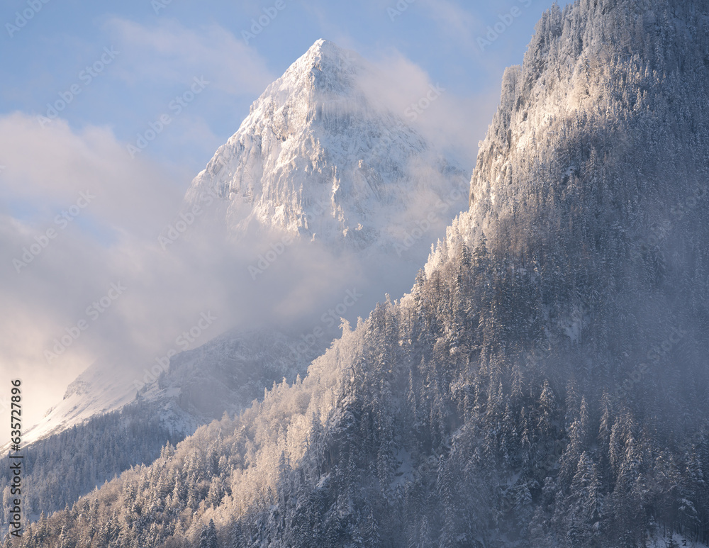 Sunlit peak with snow in winter 