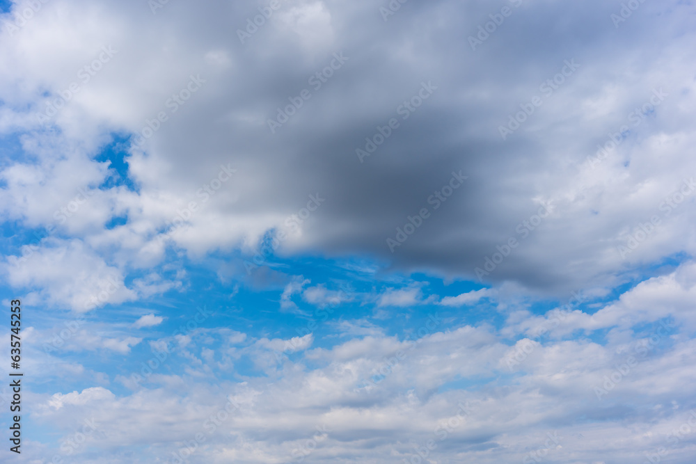 Dark clouds gather against blue sky