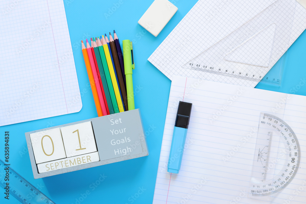 01 September. Image of a wooden calendar for September 1 on a blue table, top view. Back to school. 