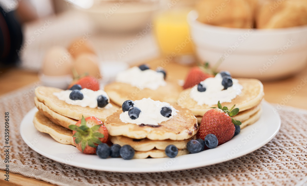 Pancakes, breakfast and fruits on table in home in the morning for protein. Bread waffle, cream and 