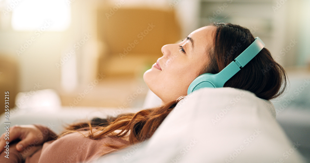 Relax, headphones and happy woman listening to music, radio or podcast while resting on sofa. Happin