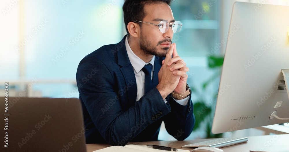 Business man analyzing a project strategy on a computer screen while working in an office. Serious a