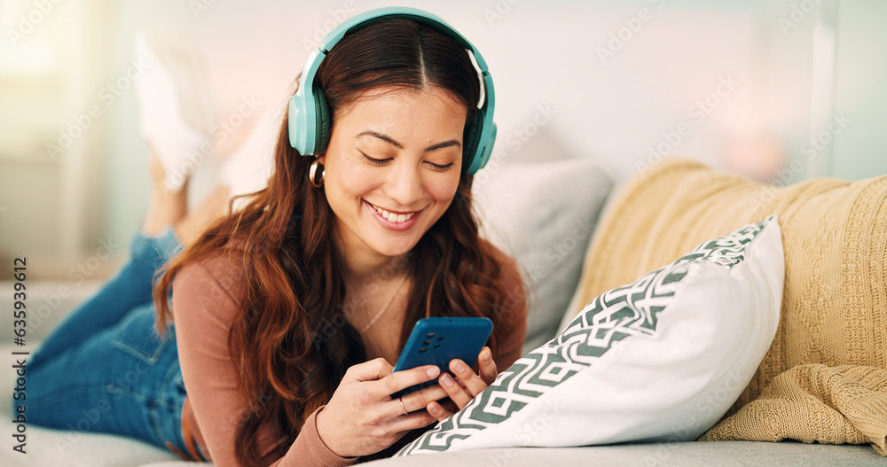 Girl, phone and music on sofa to relax with headphones with smile, typing and happy on social media.