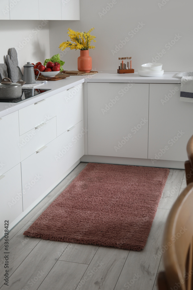 Stylish brown carpet in interior of modern kitchen