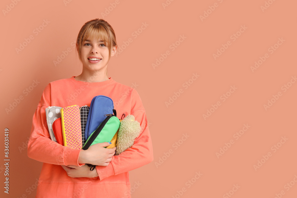 Female student with pencil cases on color background