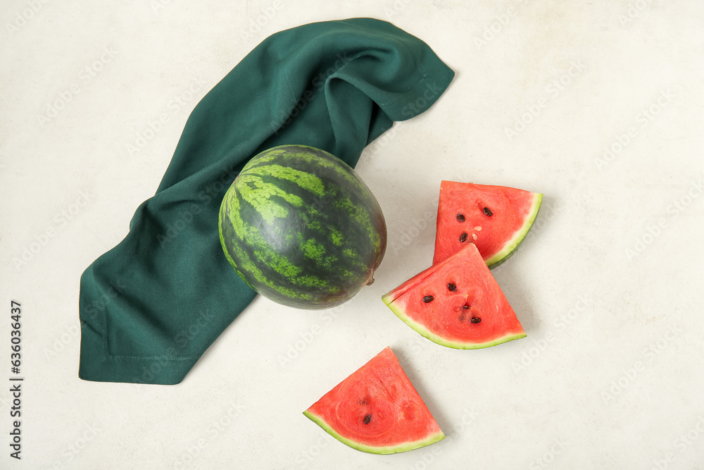 Whole ripe watermelon and pieces on light background