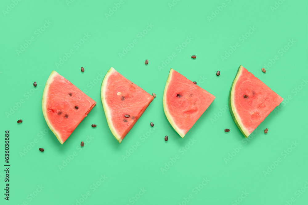 Composition with pieces of ripe fresh watermelon and seeds on green background