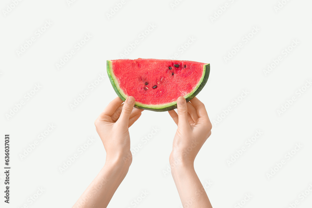 Female hands with piece of ripe watermelon on white background