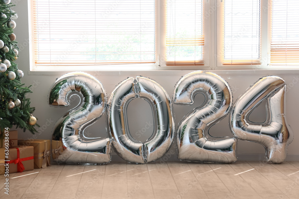 Balloons in shape of figure 2024 in light room near window