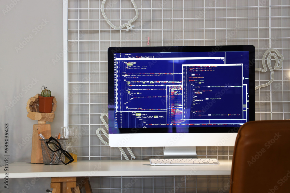 Computer monitor with code at programmers workplace in office