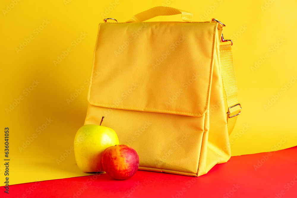 Lunch box bag and fruits on color background