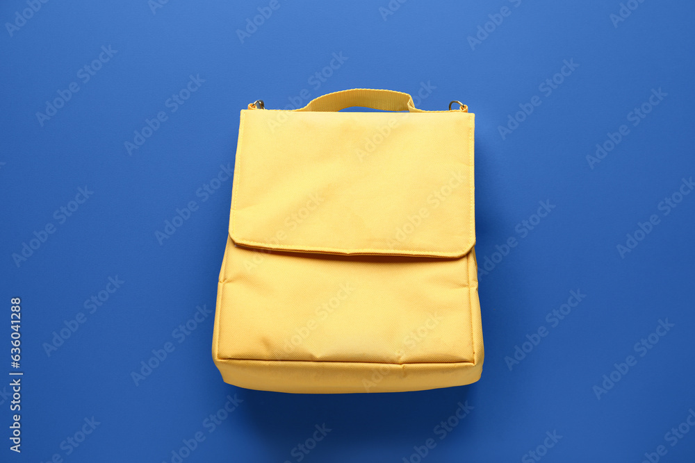 Yellow lunch box bag on blue background