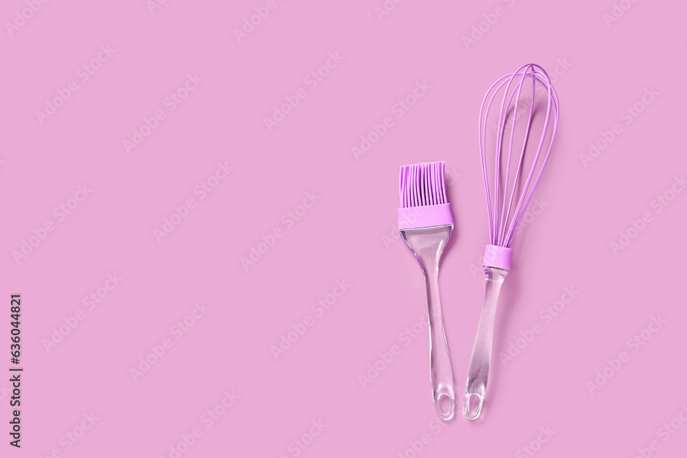 Pastry brush and whisk utensils on pink background