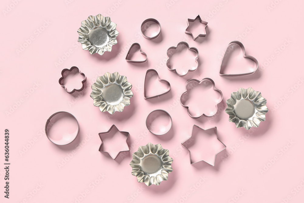 Cookie cutters on pink background