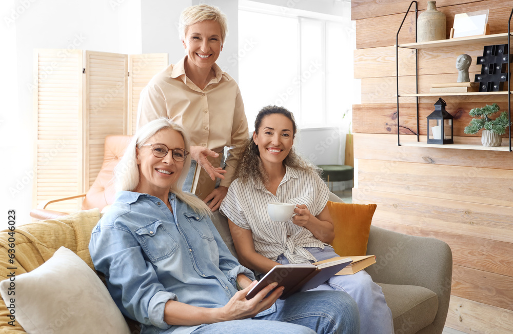 Mature women taking part in book club at home