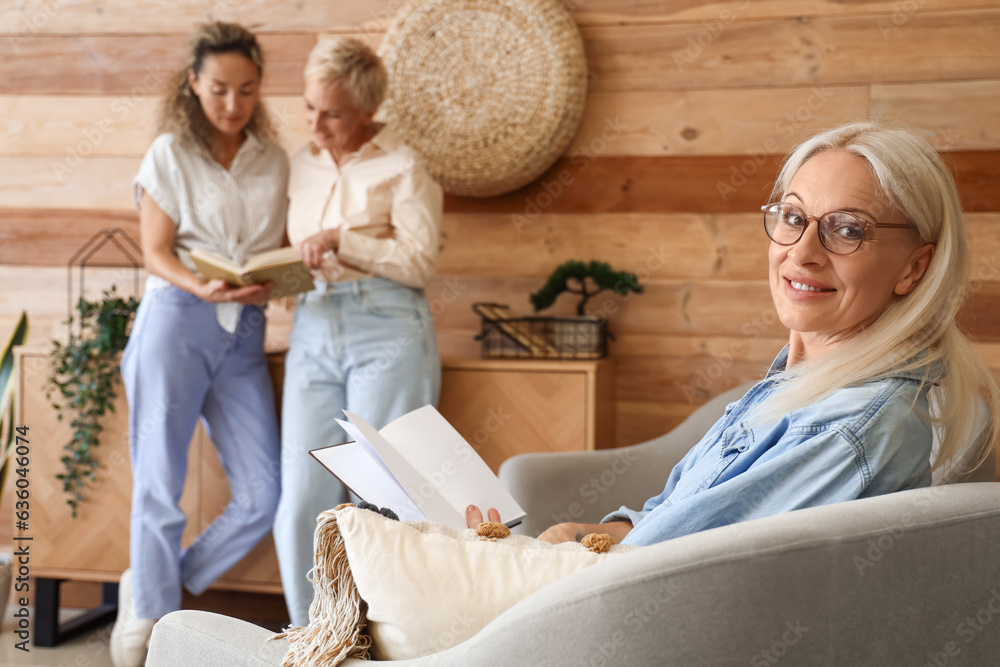 Mature woman taking part in book club at home