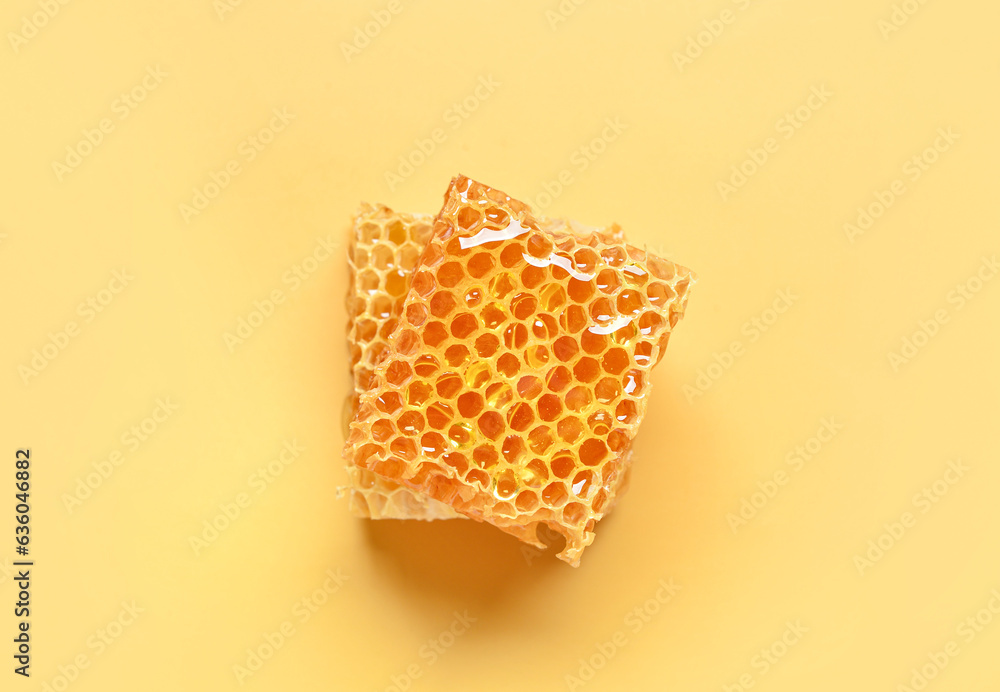 Sweet honeycombs on yellow background