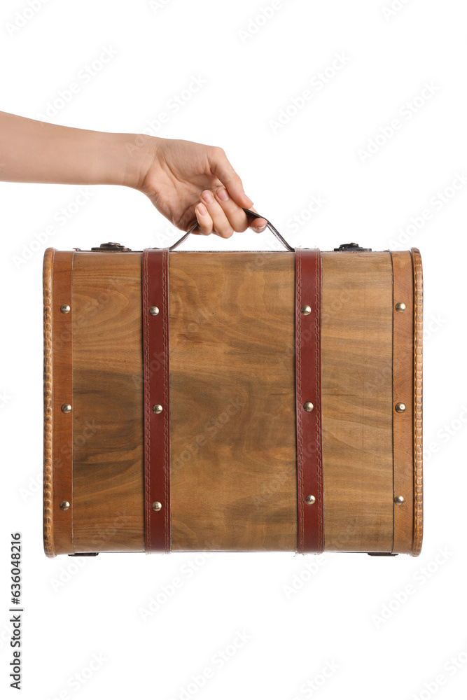 Female hand holding retro wooden suitcase on white background