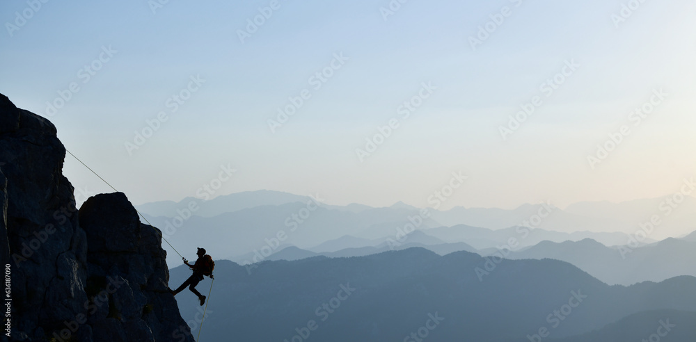 Young Man Doing Tough Rock Climbing 