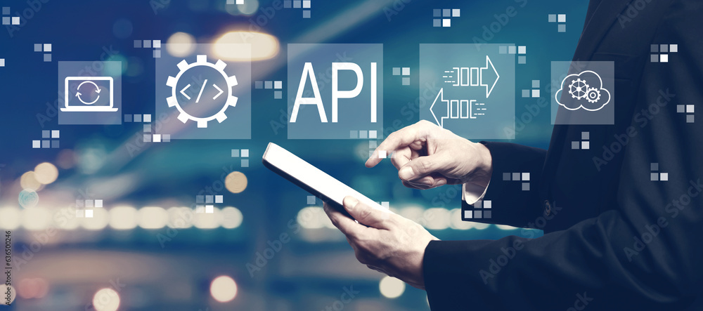 API - application programming interface concept with businessman using a tablet computer