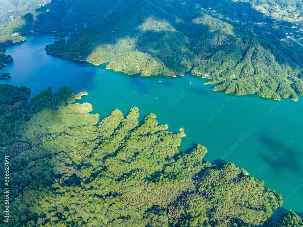 Aerial photography of a large reservoir with blue sky and white clouds and mountains