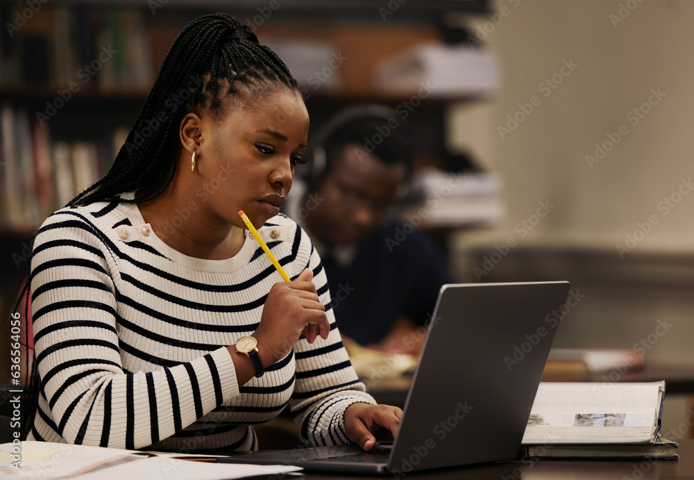 Student, woman and thinking on laptop in library for studying, research and university ideas or focu