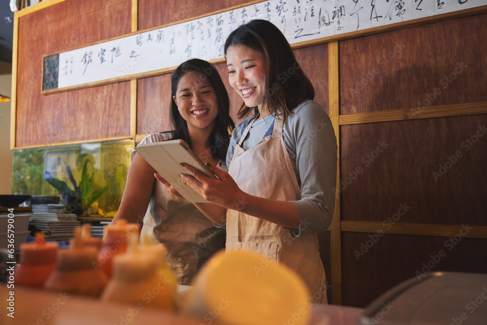 Cafe, tablet and asian women together at counter checking sales, booking or menu for small business.