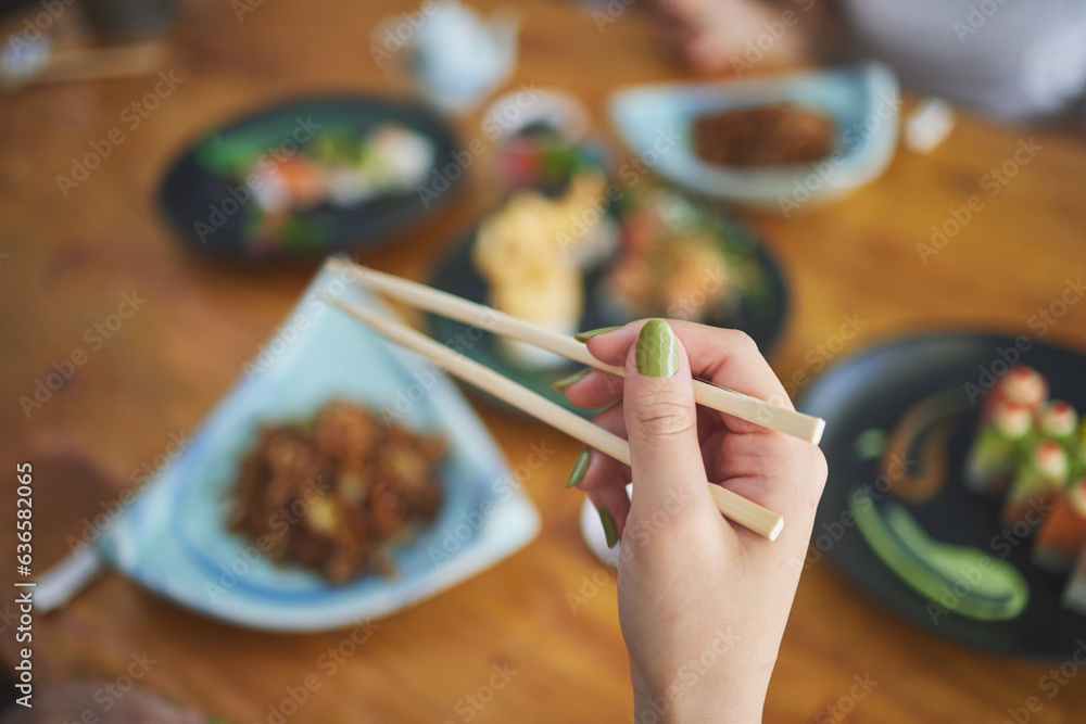 Chopsticks, hand and a person eating food at a restaurant for nutrition. Closeup of a hungry woman w